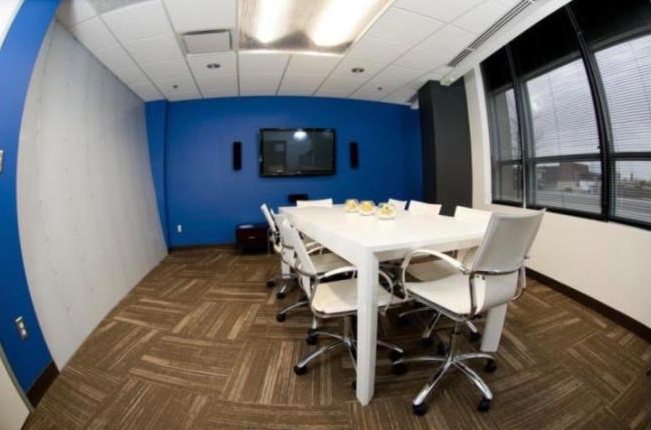Conference room with a blue feature wall and white table
